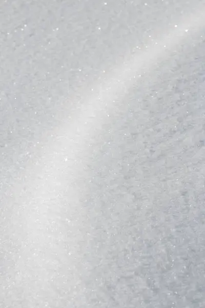 Curve of light on fresh white snow texture background