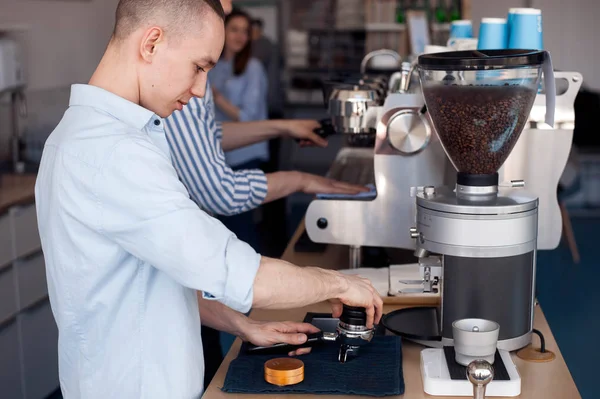 Ein Junger Mann Arbeitet Als Barista Steht Der Kaffeemaschine Und — Stockfoto