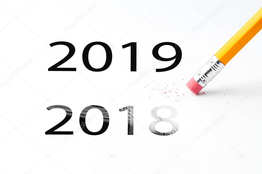 Closeup of pencil eraser and black 2018, 2019 text. Christmas background for office. Pencil with eraser.