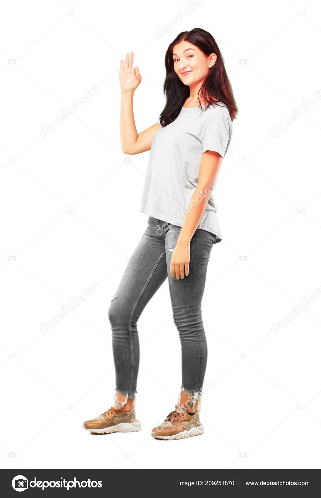 Young pretty girl full body making alright okay gesture approvingly stock photo