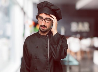 stresli ve sinirli, Kapalı gözler ve alnına el ile arayan bir şef olarak genç deli adam.