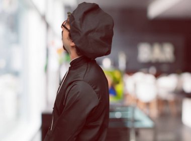 çılgın genç gülümseyen ve yukarı doğru gökyüzüne doğru veya nereye gazeteci bir kavram ya da mesaj yer noktaya bakarak bir şef olarak. Yan Dikiz.