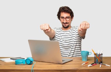 gurur, kendine güvenen ve güçlü, kapalı yumruk ile meydan okurcasına, el hareketi arıyorsunuz bir dizüstü bilgisayar ile Genç sakallı grafik tasarımcı gücünü gösteren.