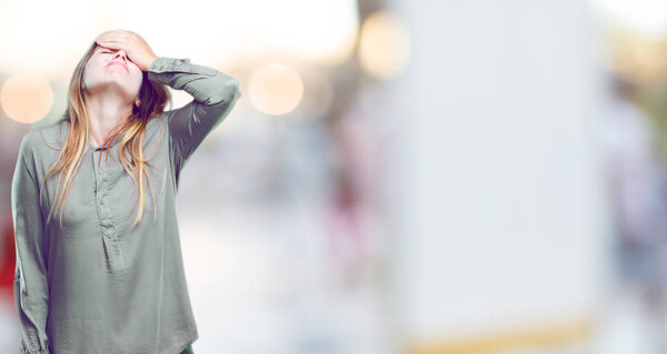 young beautiful girl with a sad look of disappointment and defeat, looking depressed and despaired, hopeless and in misery.