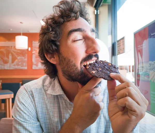 Joven Sosteniendo Una Galleta Chocolate Una Cafetería —  Fotos de Stock