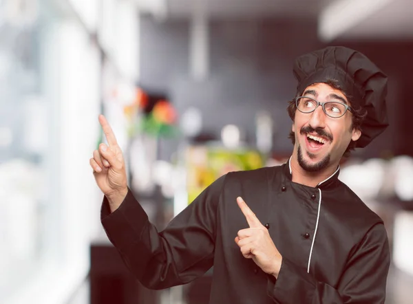 young crazy man as a chef gesturing victory, with a happy, proud and satisfied look on face, showing strength or success, celebrating an achievement.