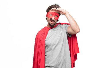 Genç süper kahraman mesafe içine uzakta seyir şaşkın bir bakışla uzak bir nesne için arama sakallı.