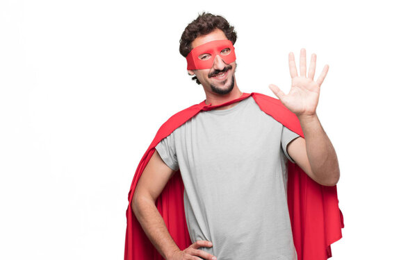 Young bearded super hero smiling and looking satisfied and happy, counting number five with fingers, with an open palm.