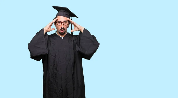 Young Graduated Man Surprised Amazed Expression Holding Both Hands Forehead — Stock Photo, Image