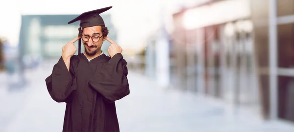 Joven Graduado Con Ambas Manos Cubriendo Oídos Para Protegerlos Ruido —  Fotos de Stock