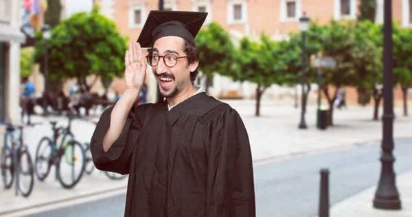 graduate bearded man paying attention, trying to hear and listen to what is being said, lending an ear.