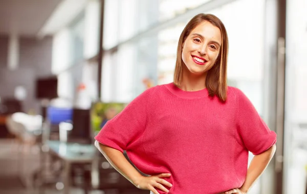 young woman full body. with a proud, satisfied and happy look, with both hands on hips, as if confidently facing a challenge. Akimbo arms pose with a broad smile.