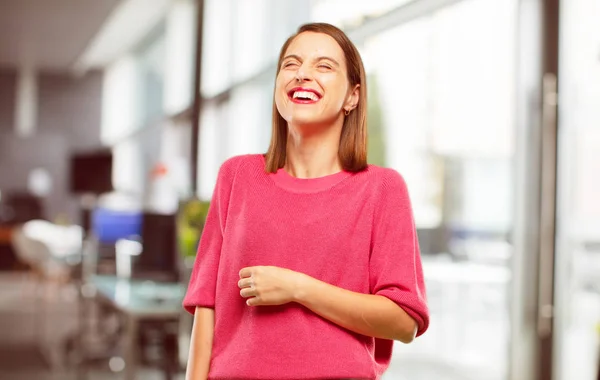 young woman full body. Laughing out loud with head tilted backwards and happy, cheerful expression