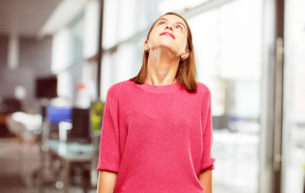 young woman full body. smiling and looking upwards, towards the sky or to the spot where the publicist may place a concept or message.