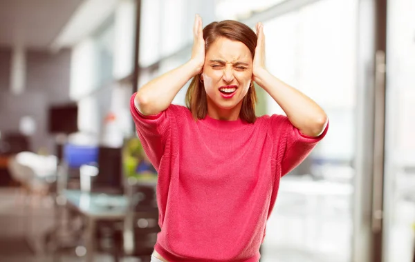 young woman full body. with both hands covering ears to protect them from an uncomfortable, loud, annoying noise.