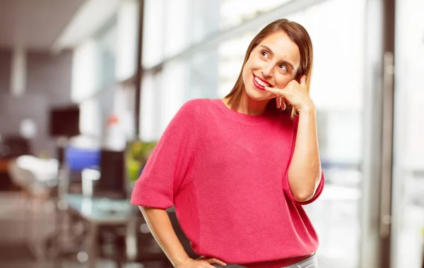 young woman full body. making a phone call gesture or sign, with a proud, happy, satisfied look; offering communication with a smile.