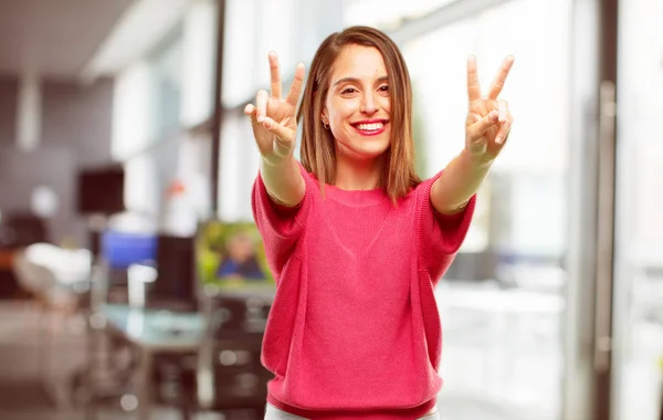 young woman full body. with a proud, happy and confident expression; smiling and showing off success while gesturing victory with both hands, giving an \