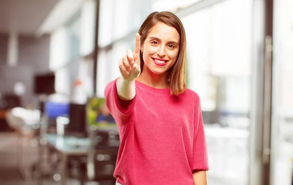 young woman full body. smiling and looking satisfied and happy, counting number with one finger.