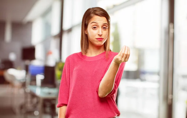 young woman full body. looking sad and worried, absolutely empty-handed, broke, in sheer bankruptcy, penny less, feeling poor and frustrated.