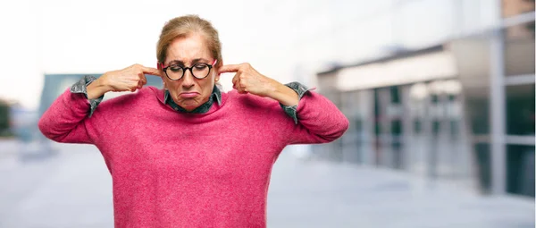 Prachtige Volwassen Blonde Vrouw Met Beide Handen Bedekking Oren Voorkomen — Stockfoto