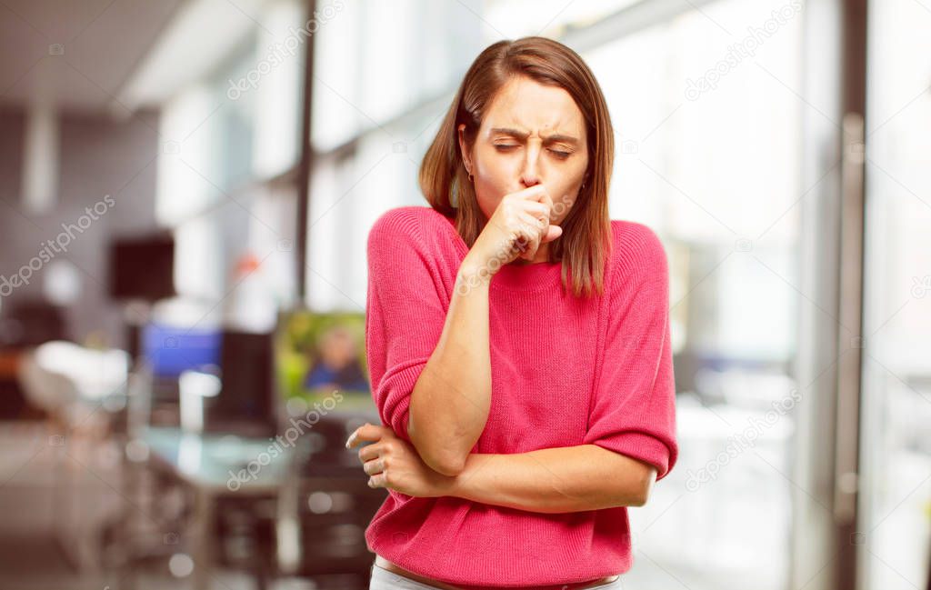 young woman full body. Coughing, suffering a winter illness such as a cold or the flu, feeling unwell and feverish.