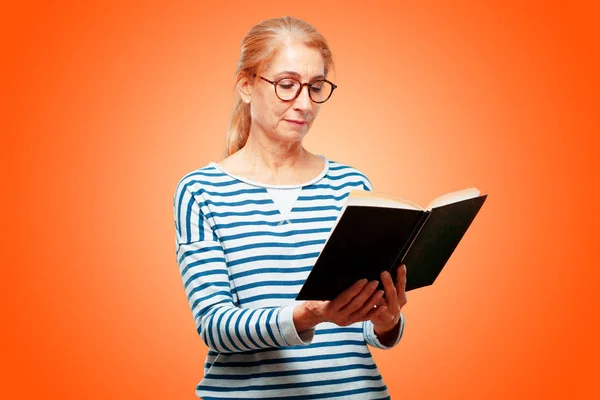 senior beautiful woman with a book