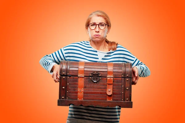 senior beautiful woman with a pirate chest