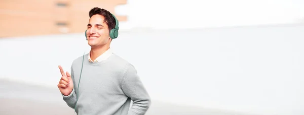 Young Handsome Tanned Man Listening Music Headphones — Stock Photo, Image