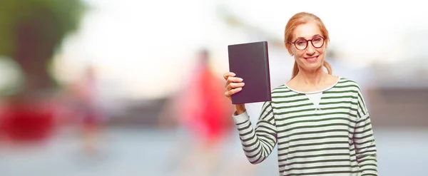 senior beautiful woman with a book