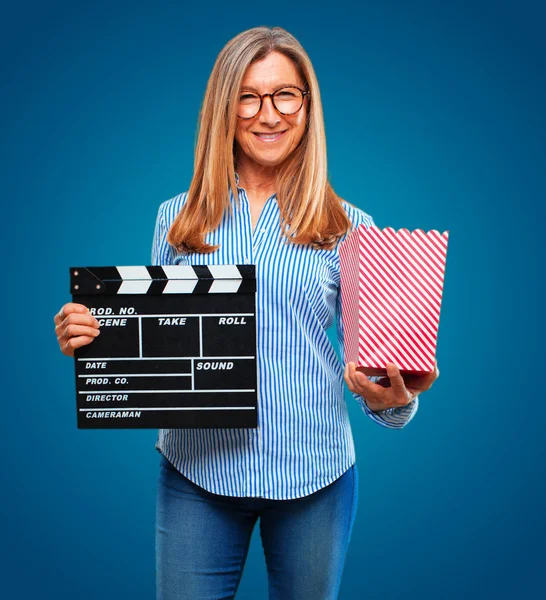 senior beautiful woman with a cinema clapper