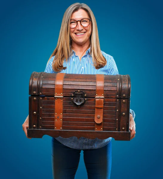 senior beautiful woman with a pirate chest