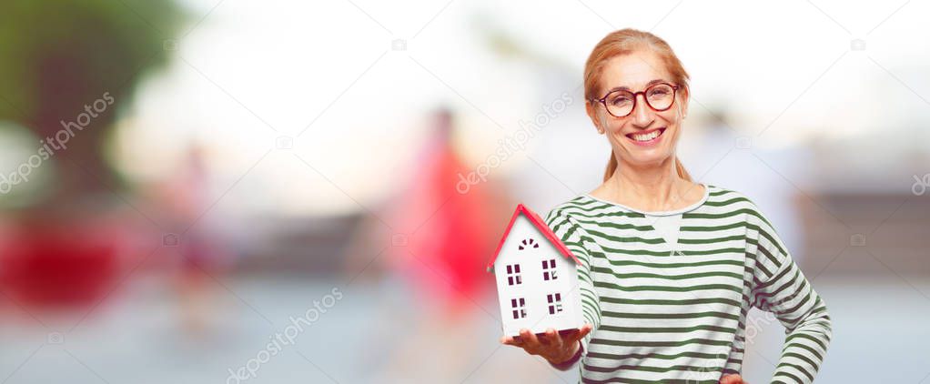 senior beautiful woman with a house model