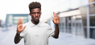 Genç serin siyah adam işareti. tek renkli bir arka plana dayanır kişi kesip