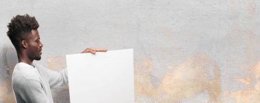 Senin konseptin yerleştirmek için boş bir afişini tutan genç siyah adam