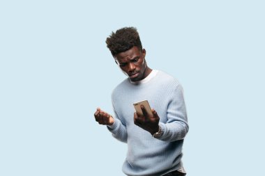 Genç siyah adam akıllı bir cep telefonu kullanarak