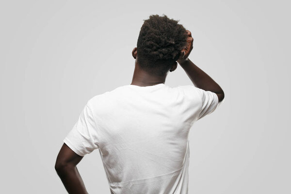 Young cool black man sign. cut out person against monochrome background