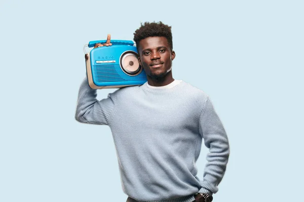 young black man with a vintage radio