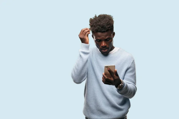 young black man using a smart mobile telephone