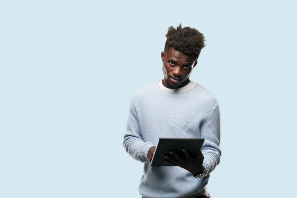 young black man using a smart tablet