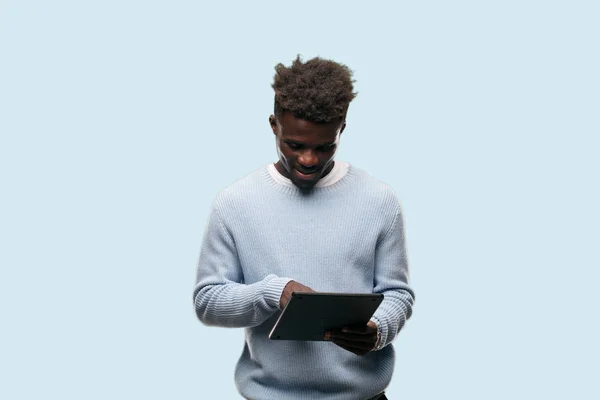 young black man using a smart tablet