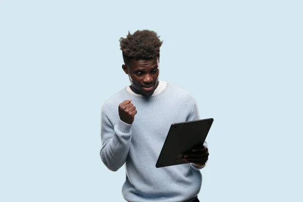 young black man using a smart tablet