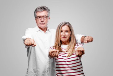 üst düzey serin karı koca bakarak gurur, kendinden emin ve güçlü, ile eller yumruk meydan okurcasına, gücünü gösteren kapalı.