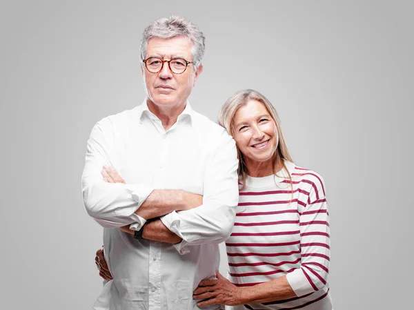 stock image senior cool husband and wife with a satisfied and happy look on her face, smiling sincerely an affectionate smile.