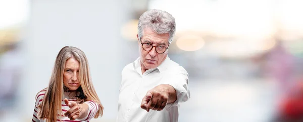 Senior Cool Husband Wife Looking Angry Surprised Shouting Pointing Forward — Stock Photo, Image