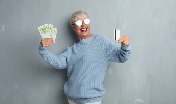 Senior Cool Vrouw Met Een Credit Card Tegen Grunge Cement — Stockfoto