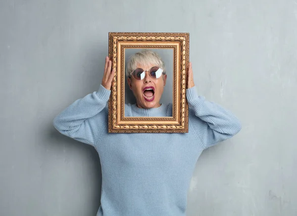 Senior Cool Vrouw Met Een Barok Frame Tegen Grunge Cement — Stockfoto