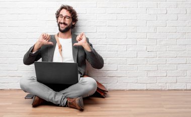 gurur, mutlu ve kendine güvenen bir ifade ile katta oturan genç adam; gülümseyen ve başarı, emin birine dönüktür kendini iki elle, bir 