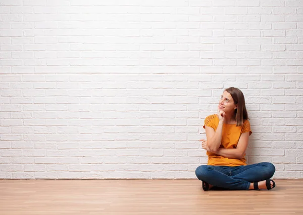 Young Pretty Woman Thinking Looking Pensive Empty Place Brick Wall — Stock Photo, Image