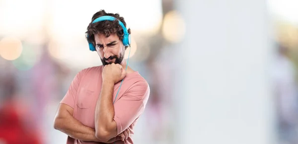 young bearded man With a confused and thoughtful look, looking sideways, thinking and wondering between different options.