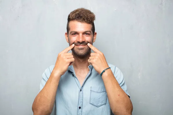 Young Handsome Man Forcing Smile Face Both Index Fingers Sending — Stock Photo, Image